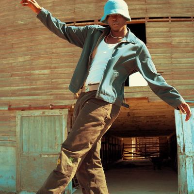 Person balancing on one leg in a sunny room.