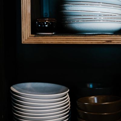 Yoga blocks stacked neatly on a wooden shelf.